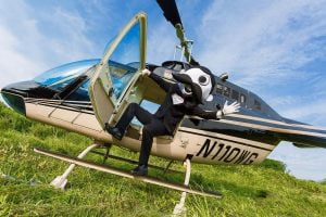 Natty Boh character stepping out of a helicopter from Charm City Helicopters in a suit.