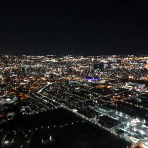 Aerial night view overlooking Baltimore City from a helicopter from Charm City Helicopters.