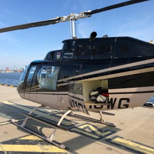 Helicopter on landing pad with golf clubs in the baack.