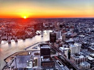 Aerial view of Baltimore City during sunset from a helicopter provided by Charm City Helicopters.
