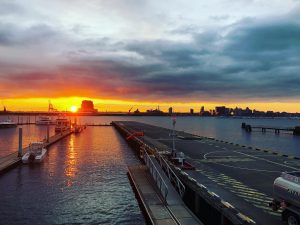 Sunset overlooking the Baltimore waterfront with a helicopter landing pad.