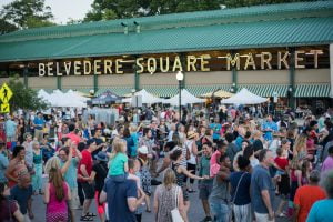People enjoying a sunny day shopping in Belvedere Square.