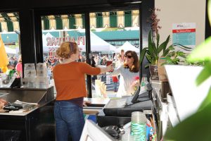 Girl giving a woman her smoothie from the window of Plantnbar in Belvedere Square.