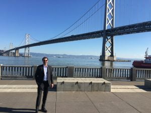 Scott Plank standing by the San Francisco bridge after working on developing The Hall SF.