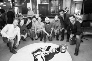 Scott Plank and his team posing in The Hall SF after its completion in San Francisco.