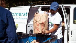 Cornerstones volunteers transporting food