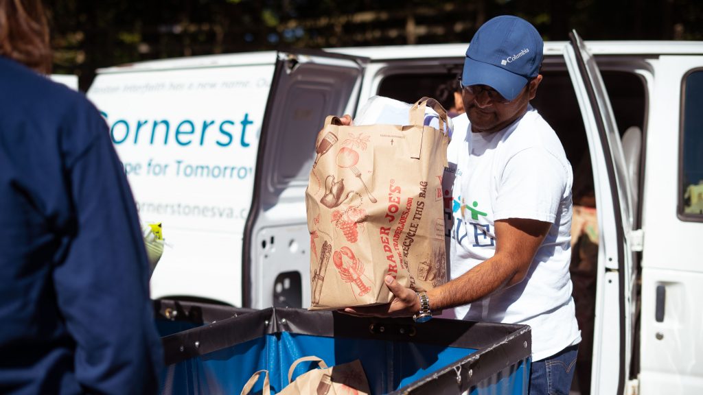 Cornerstones volunteers transporting food