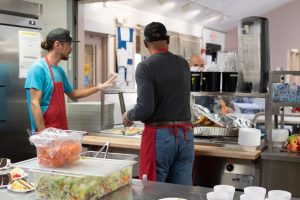 cornerstones volunteers preparing food as donations